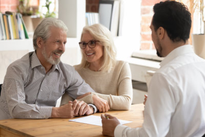 elderly couple talking to a healthcare personel