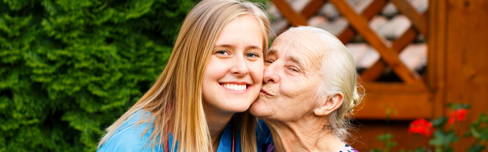 caregiver kissed by senior woman