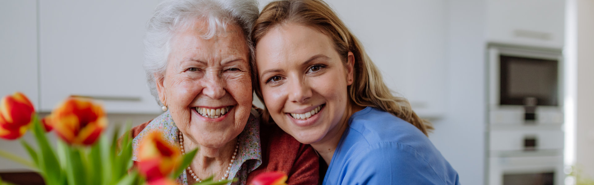 caregiver with senior woman smiling